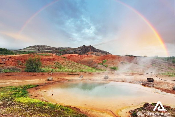 colourful geysir geothermal area view with a rainbow