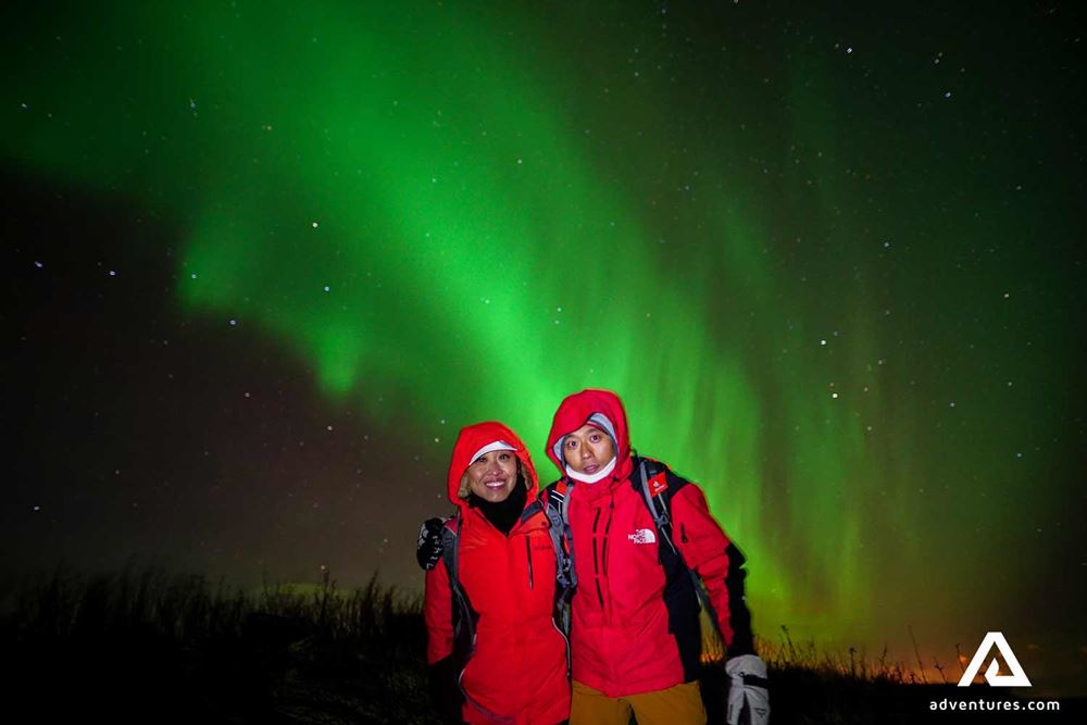 a couple watching northern lights in Iceland
