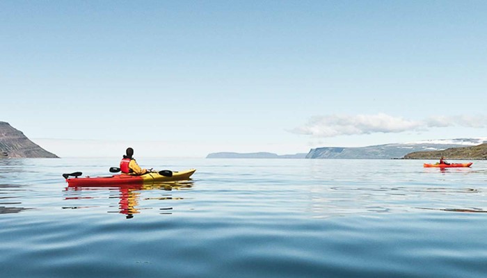 kayaking in a calm water sea in Iceland