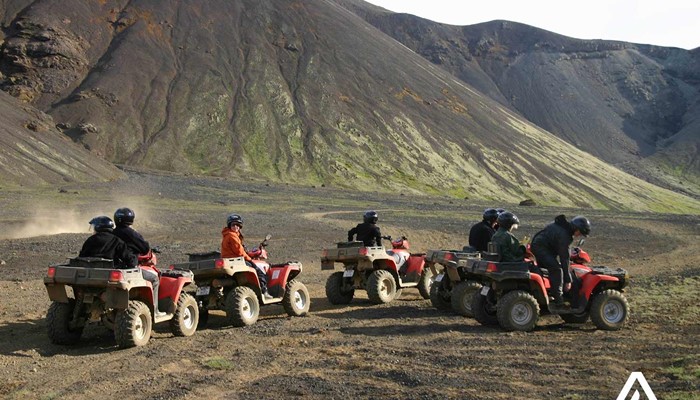 Group riding ATV in mountains in Iceland