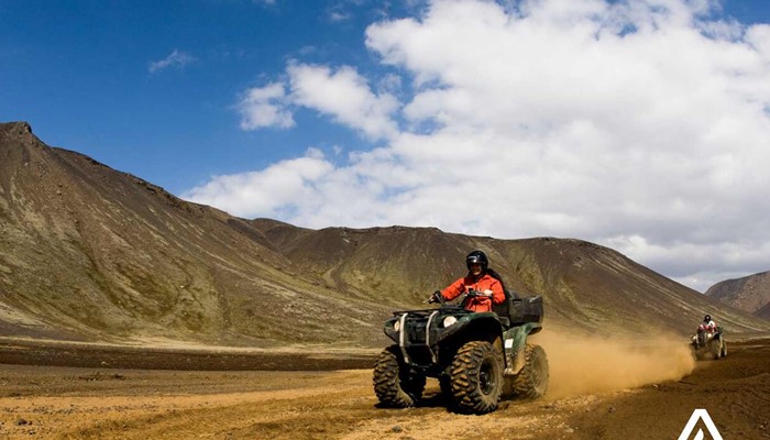 Fast ATV riding through gravel roads in Iceland