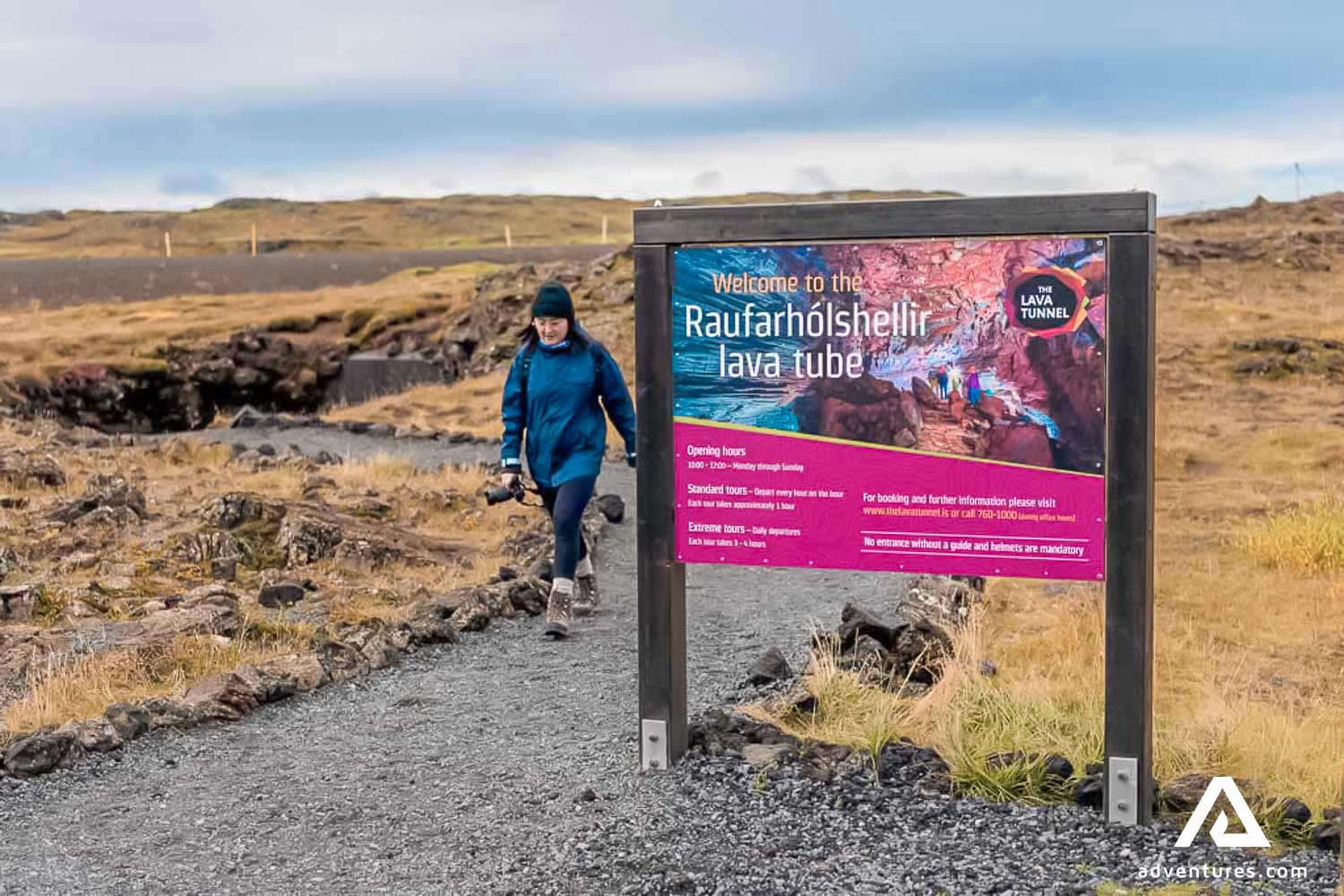 A woman walking from lava tunnel