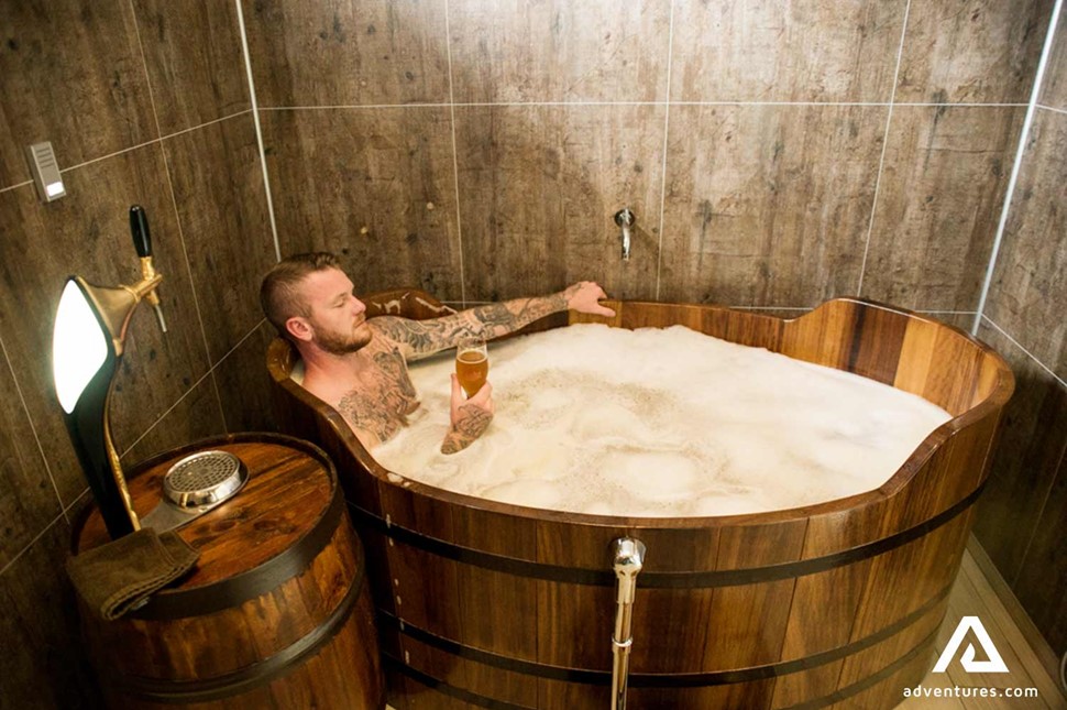 Man relaxing in a beer spa hot tub in Iceland