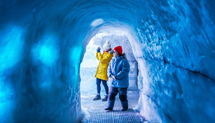 people walking in an artificial ice cave in perlan
