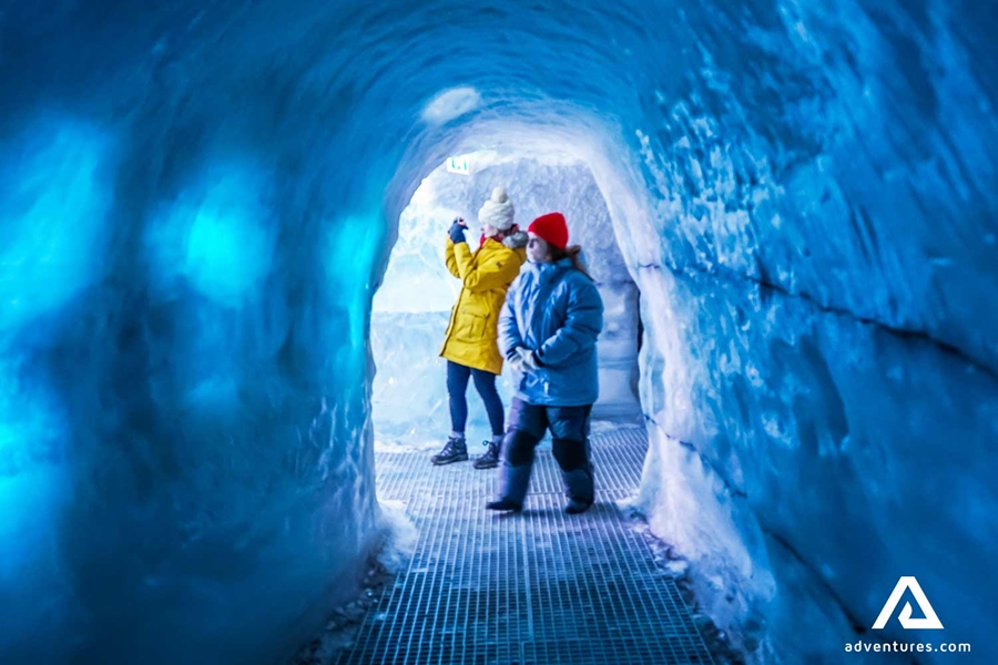 people walking in an artificial ice cave