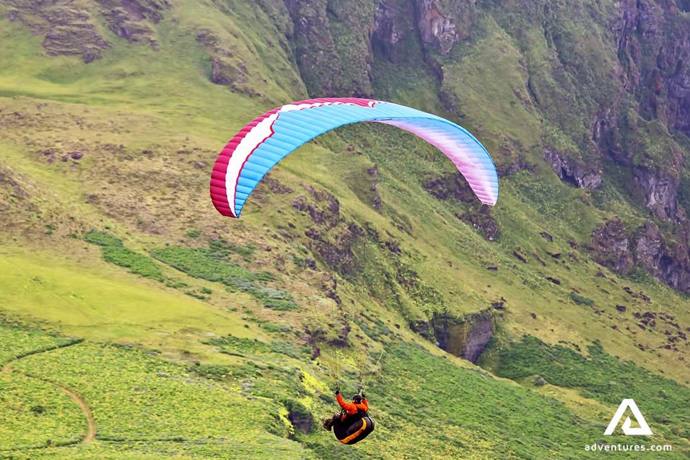 solo paragliding over the mountains
