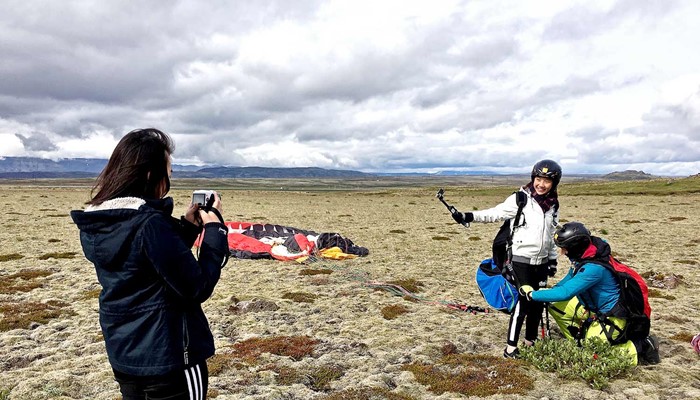 happy people after paragliding tour in iceland