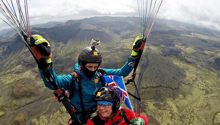 paragliding with an icelandic flag on a tour