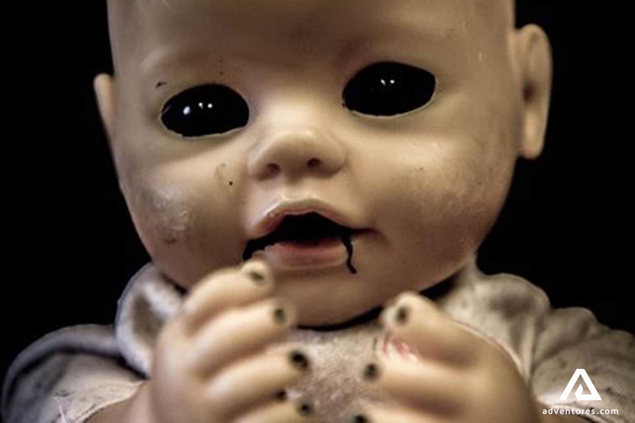 scary baby doll in an escape room