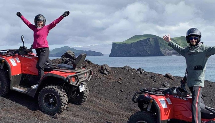 happy couple on an atv riding tour in westman island