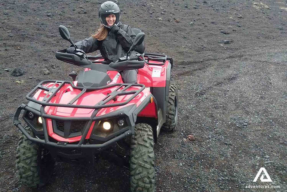 woman posing for a picture on a quad bike