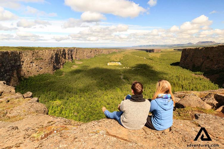 two tourists near the asbyrgi canyon two tourists near the asbyrgi canyon in the north of iceland
