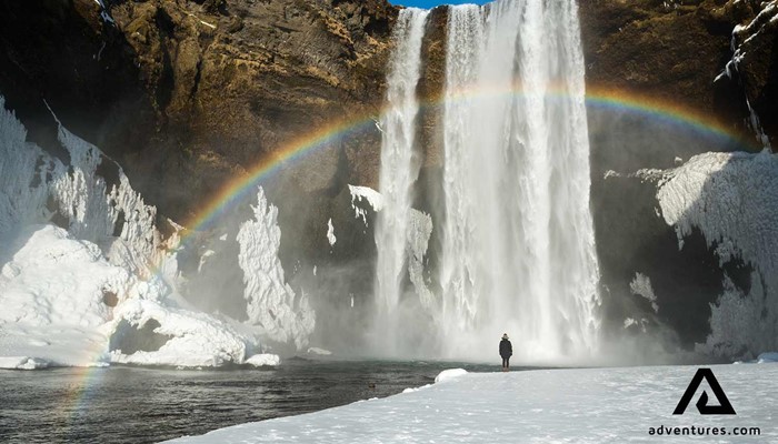 skogafoss waterfall in winter with a rainbow