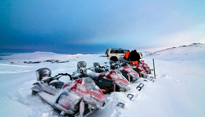 Snowmobiles with snow on Myrdalsjokull glacier