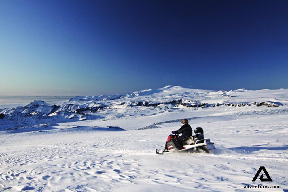 solo snowmobiling on a glacier