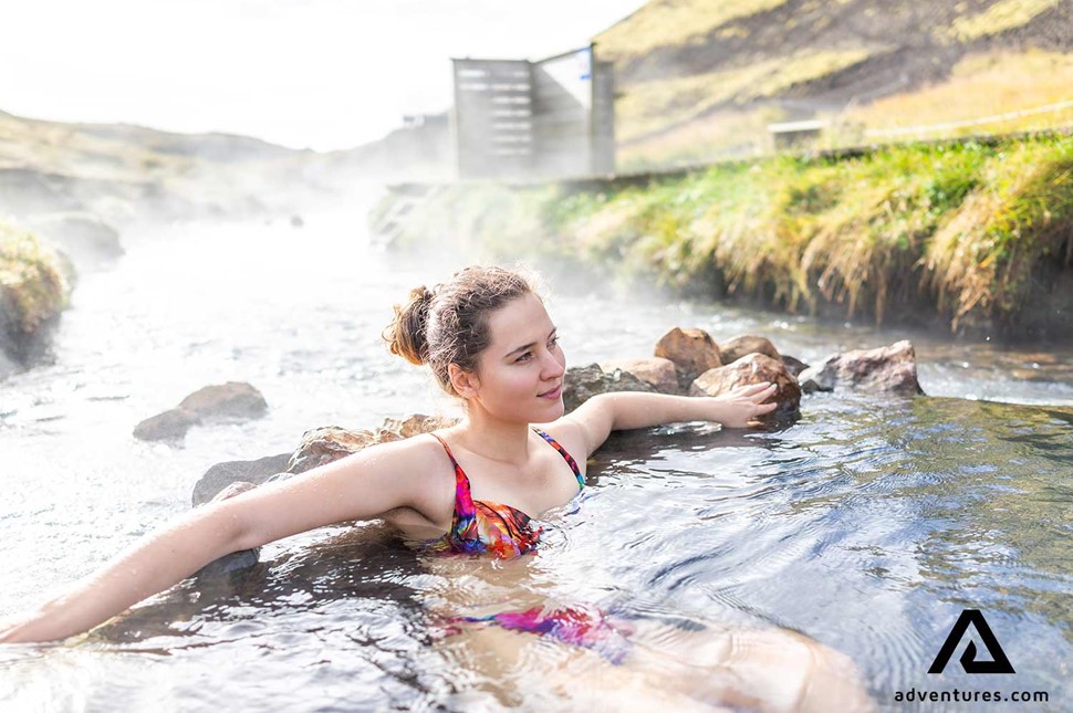 woman enjoying a hot spring near hveragerdi