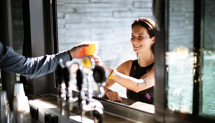 woman taking a cocktail from a bar at geosea