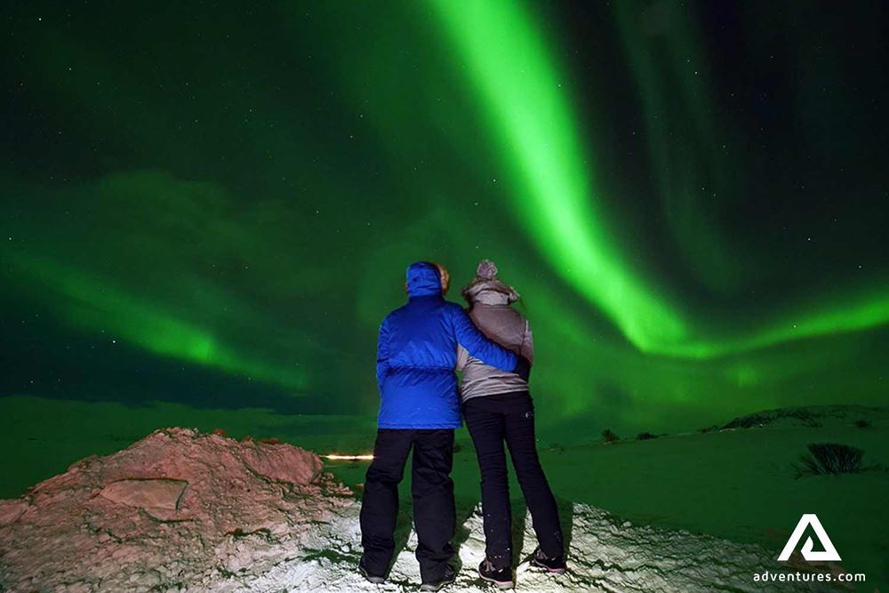 couple watching aurora borealis