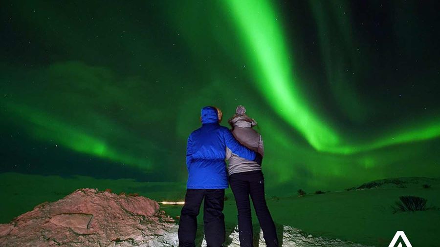 couple watching aurora borealis