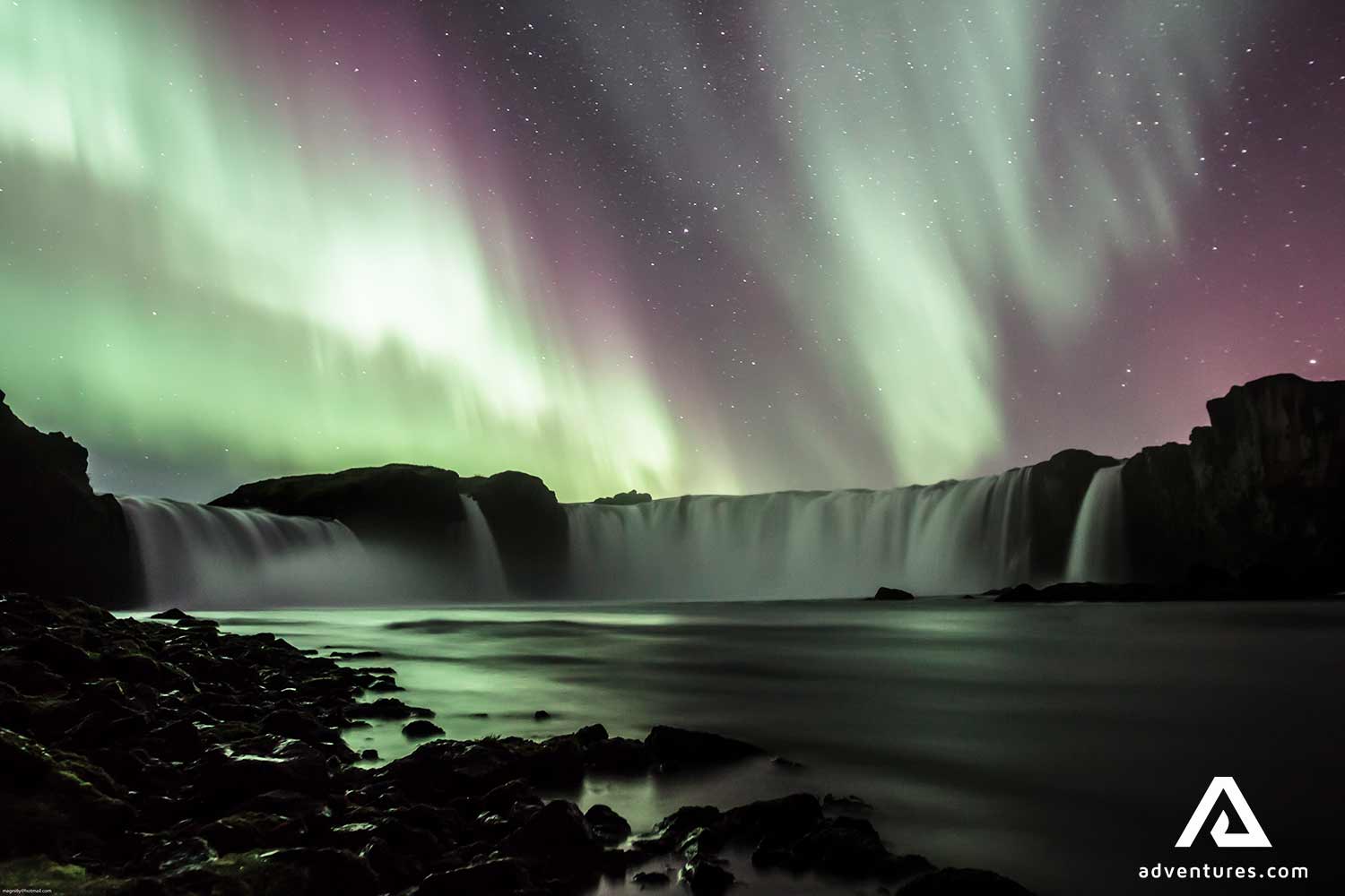 aurora borealis above godafoss waterfall