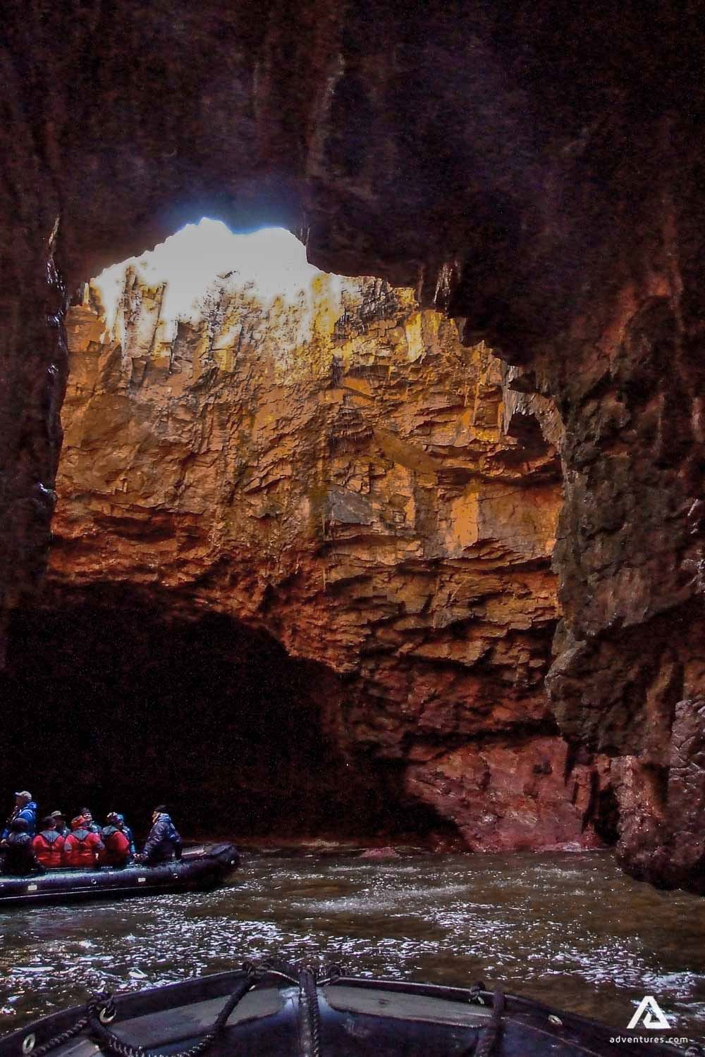 Boat under the cliff cave in Scotland