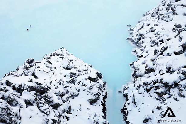 aerial view of two people in the blue lagoon at winter