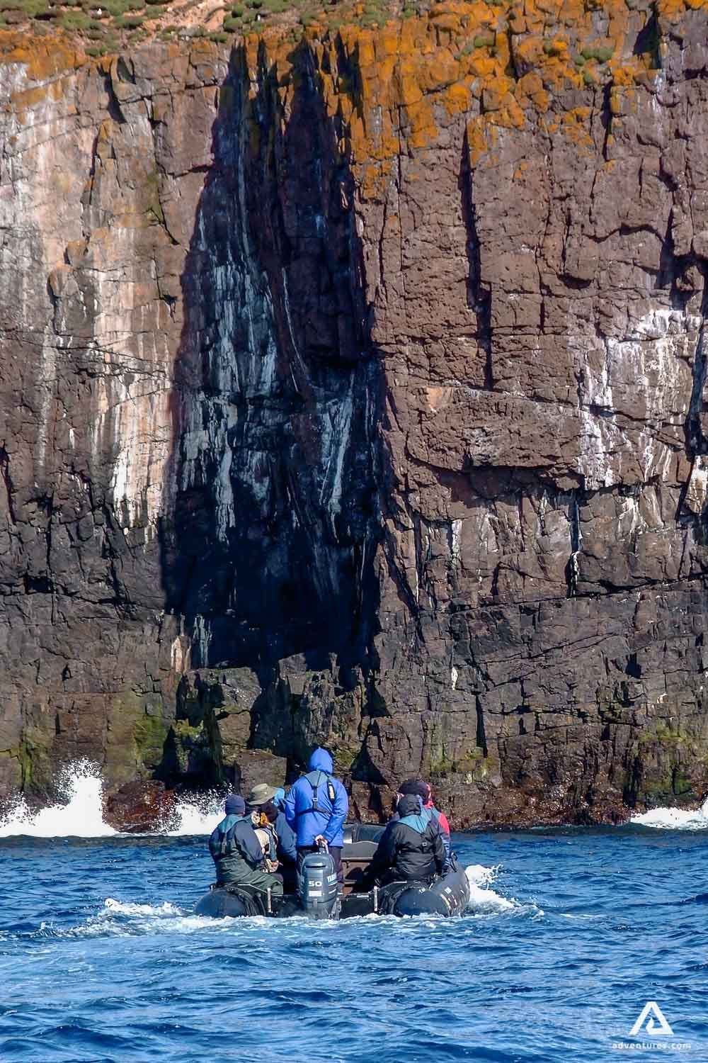 Exploring cliff on a boat in Scotland