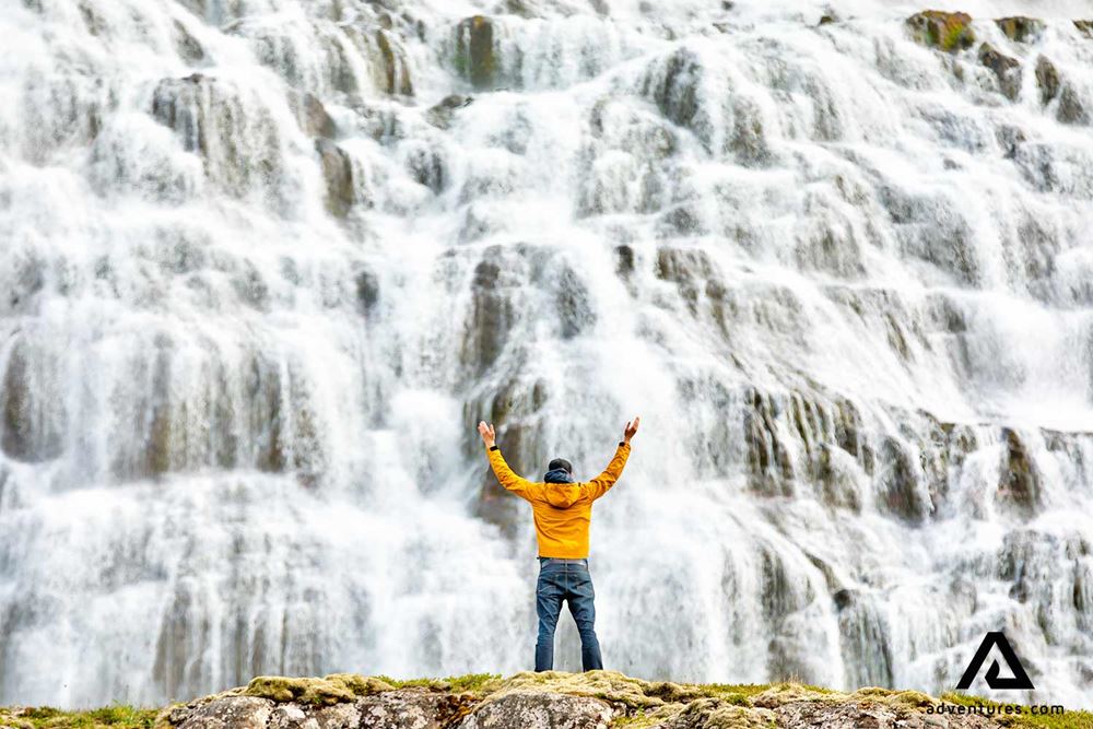 man near a big waterfall dynjandi