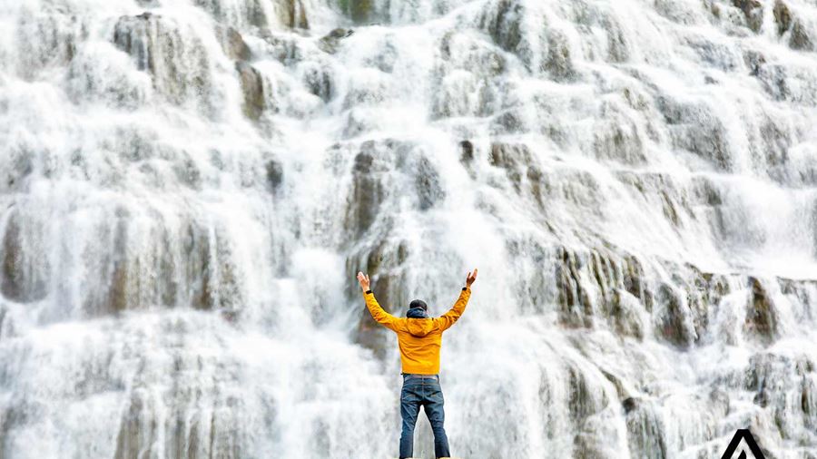 man near a big waterfall dynjandi