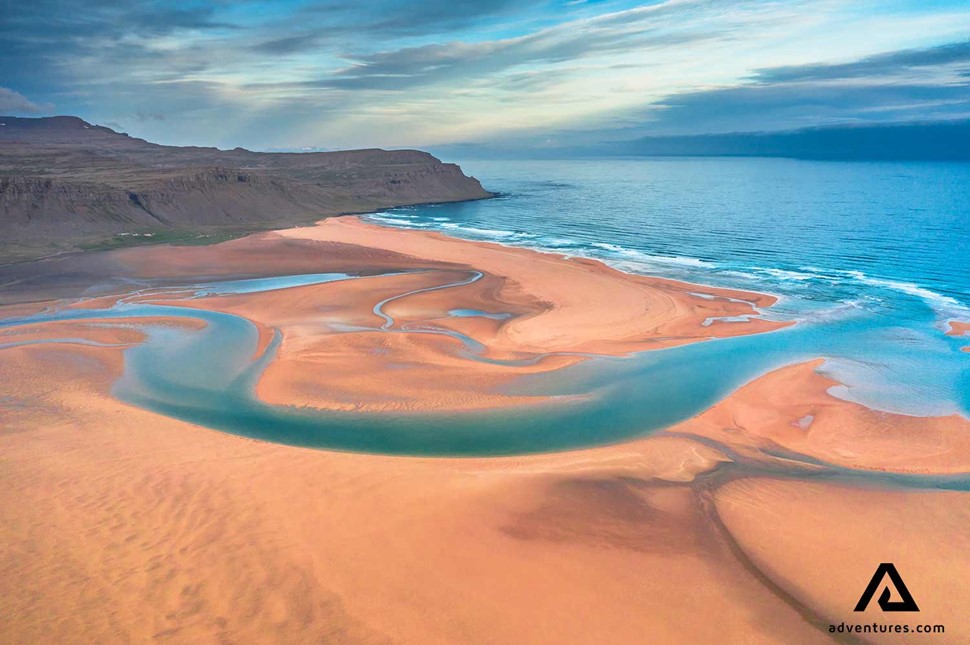 red sand beach in westfjords in iceland