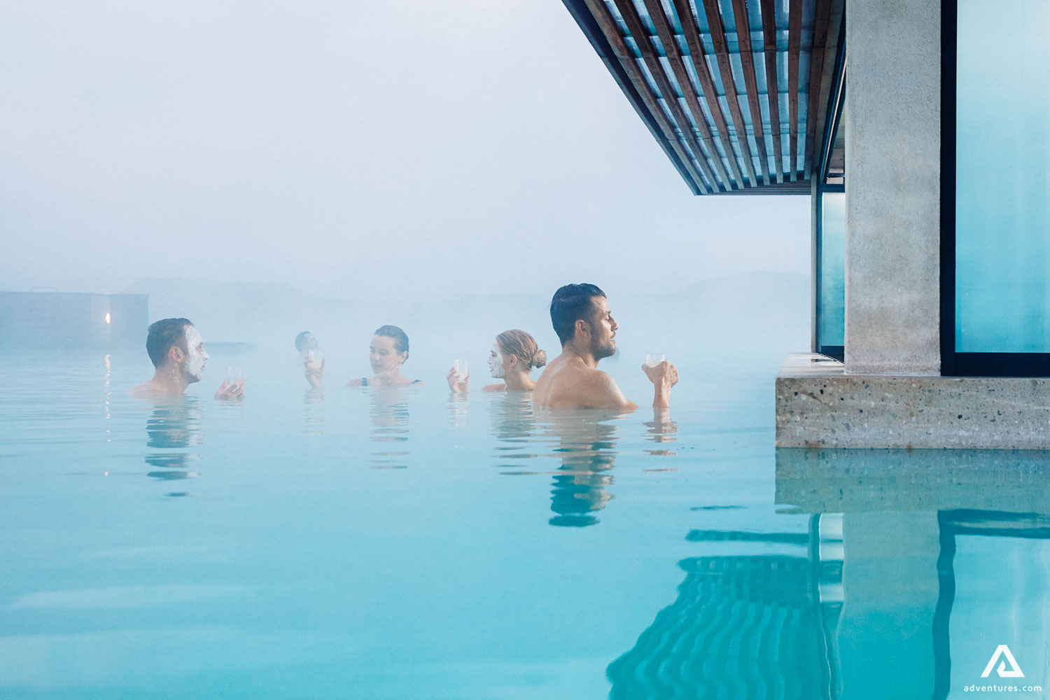 people bathing near a bar at blue lagoon in iceland