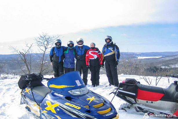 A group of people on snowmobiling tour