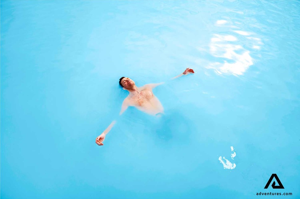 man bathing in blue lagoon in reykjanes