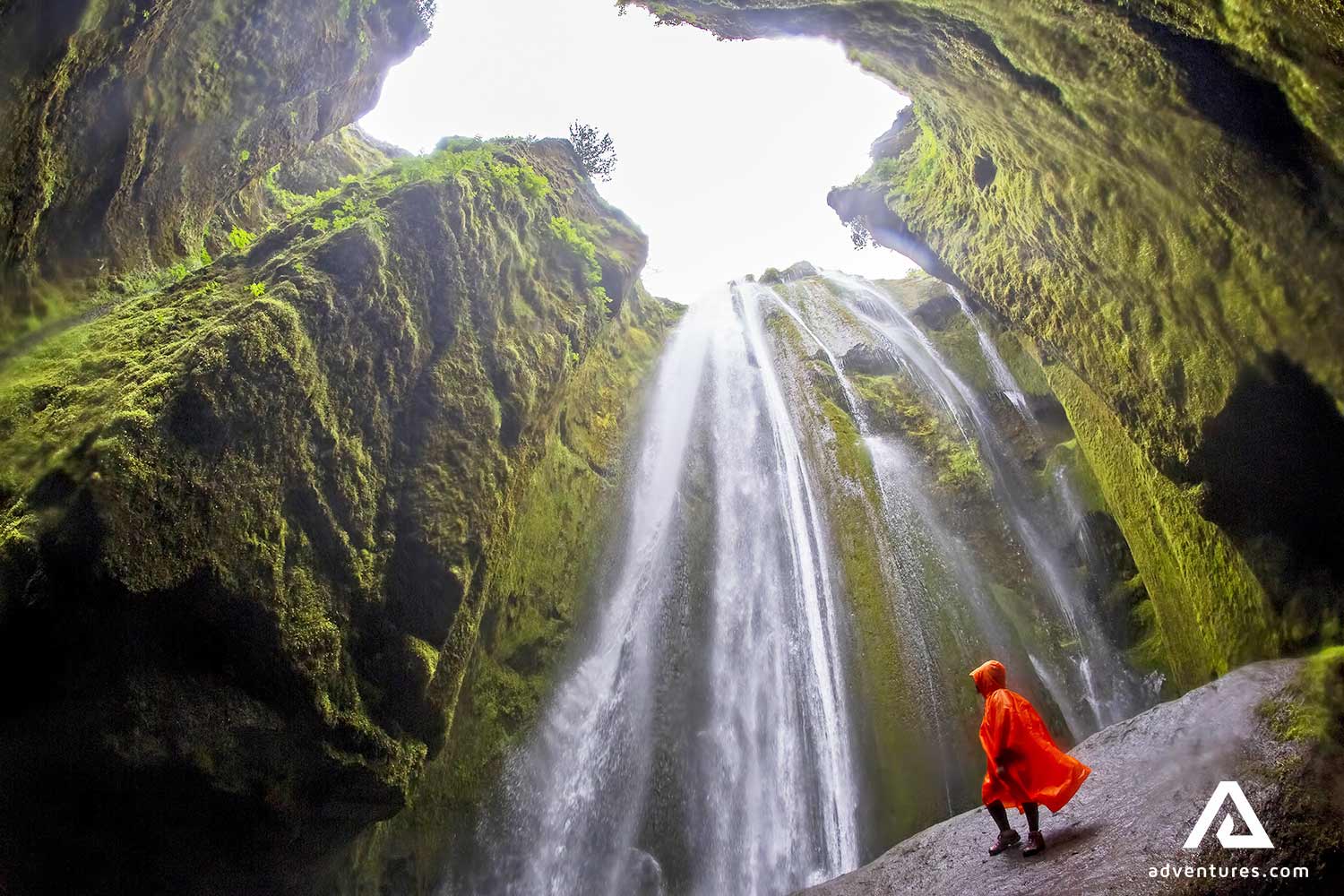 standing with a raincoat near gljufrabui waterfall