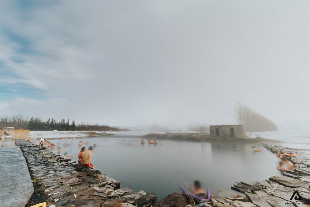 people bathing in secret lagoon