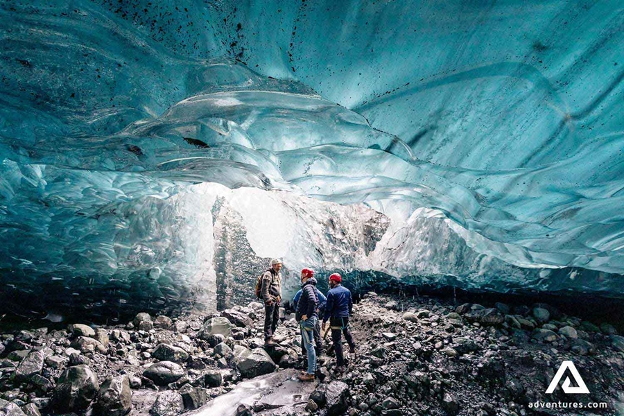three men exploring crystal ice cave