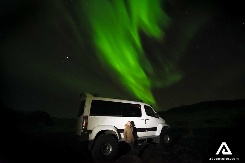 aurora borealis near a super jeep in iceland