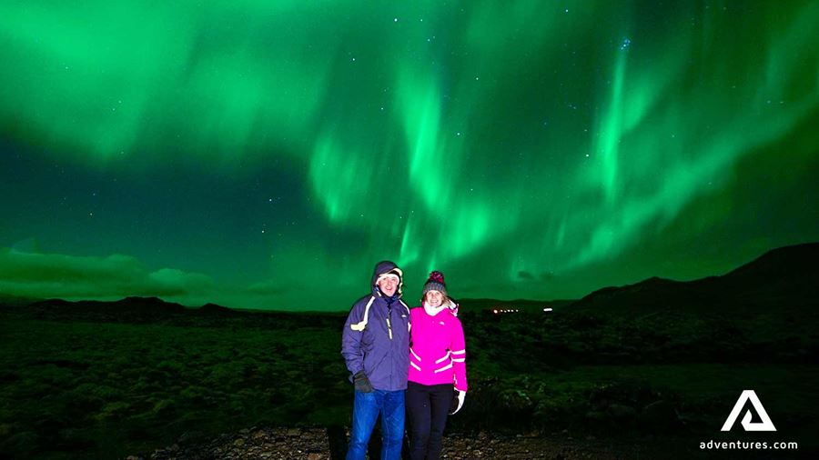 posing for a picture near northern lights