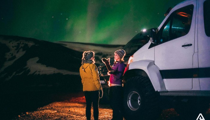 talking about northern lights with a friend in iceland