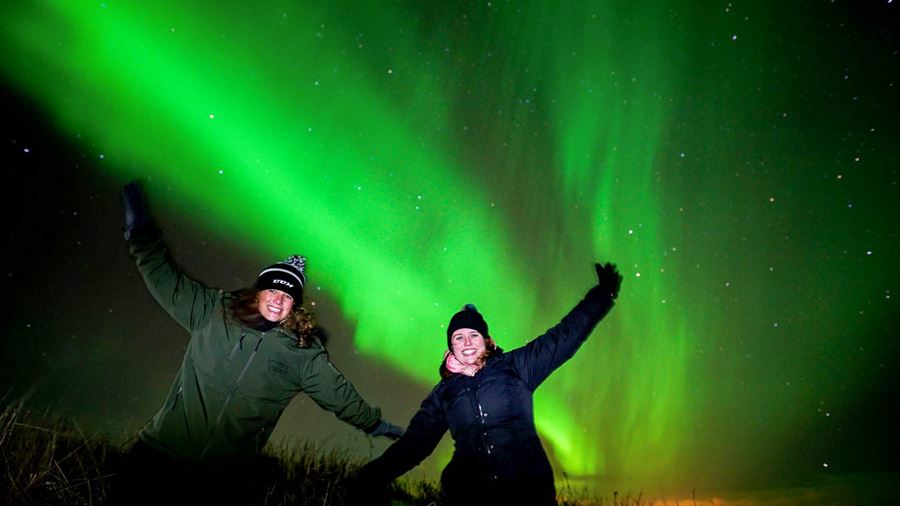 watching northern lights with a friend in iceland