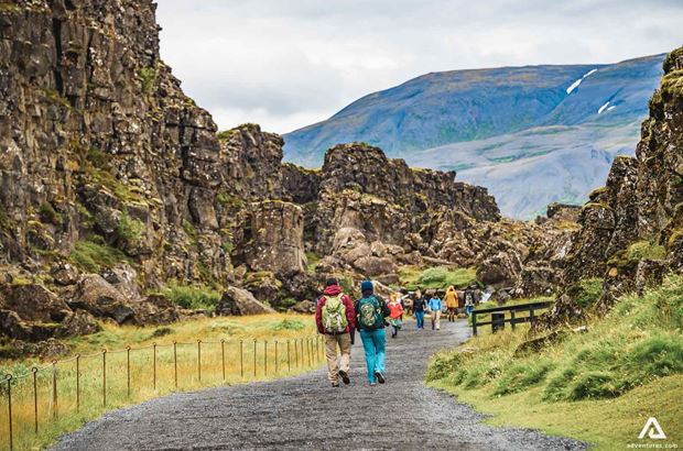 people walking down the path in thingvellir people walking down the path in thingvellir national park