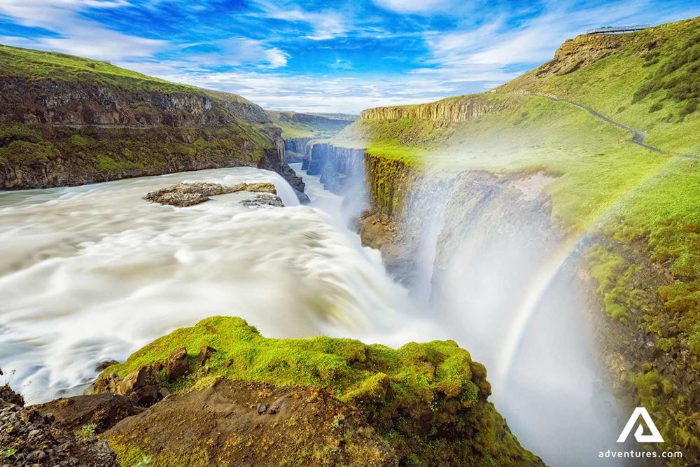 side view of gullfoss waterfall with a rainbow