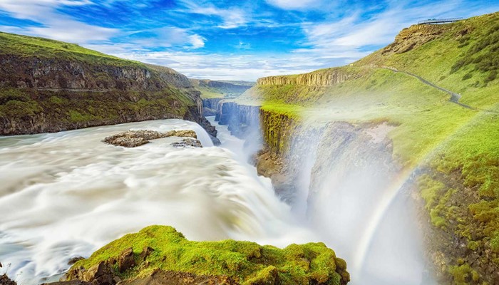 side view of gullfoss waterfall with a rainbow in iceland