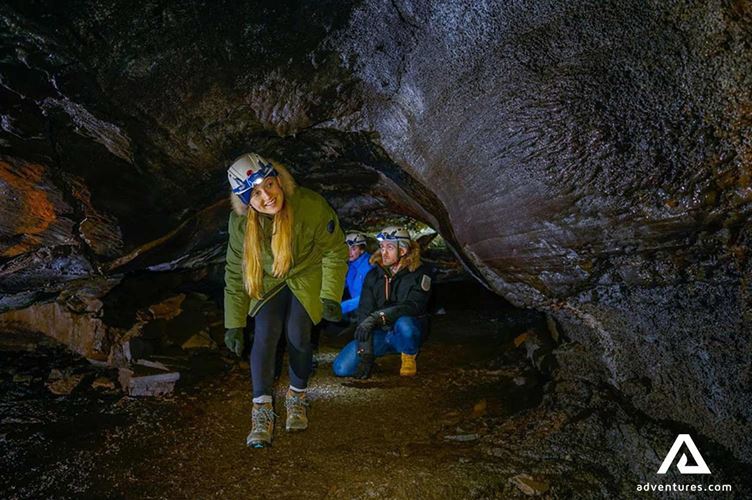small group happy while exploring lava cave small group happy while exploring lava cave in reykjanes