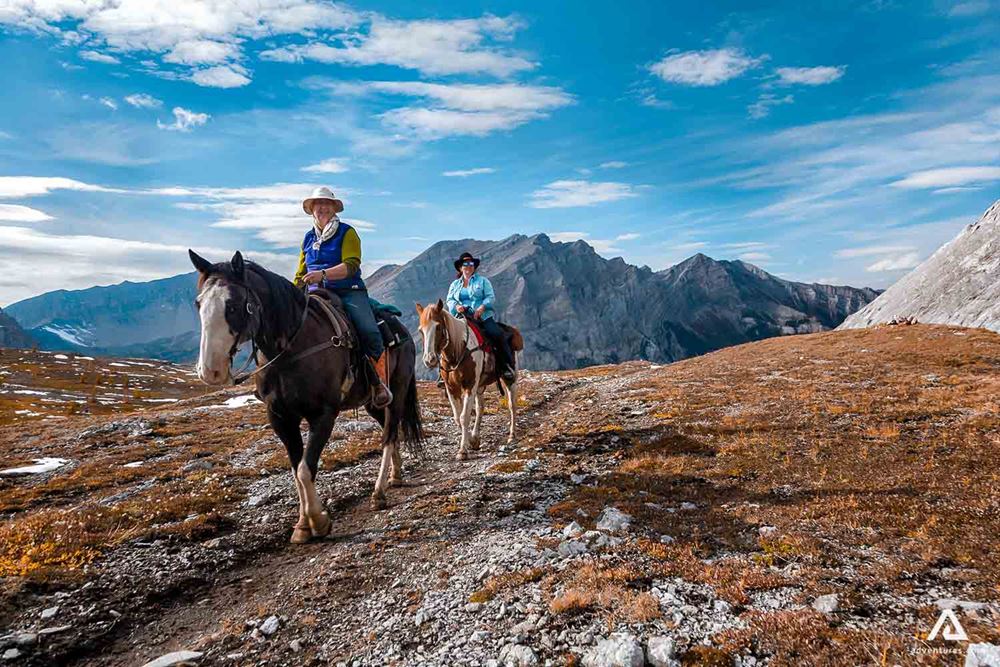Happy tourists on a horseback tour in Canada