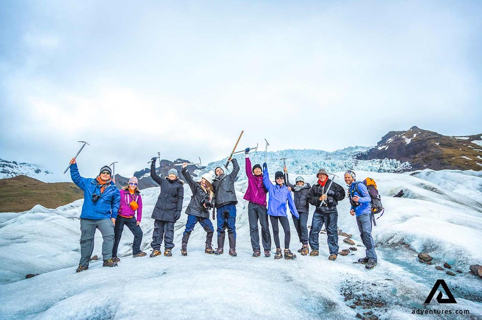 happy group posing for a picture on falljokull glacier