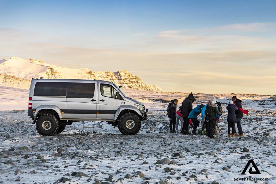 a group near a super jeep on a glacier in iceland