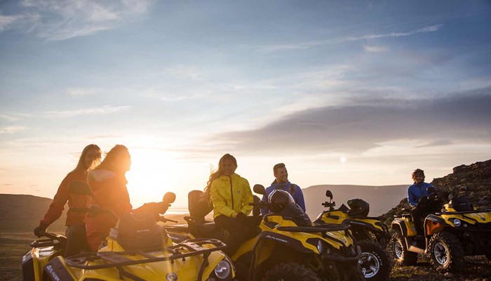 friends atv riding at sunset in iceland