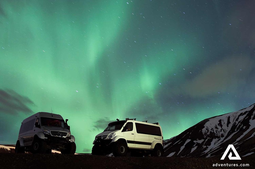 super jeeps below northern lights in iceland