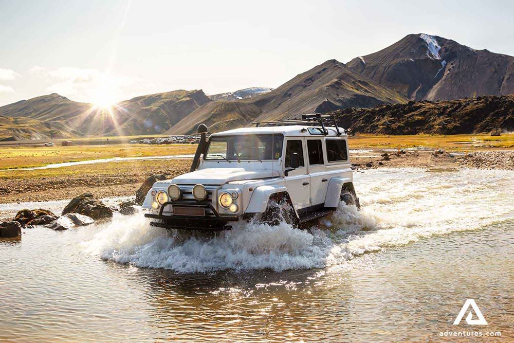 super jeep crossing a shallow river